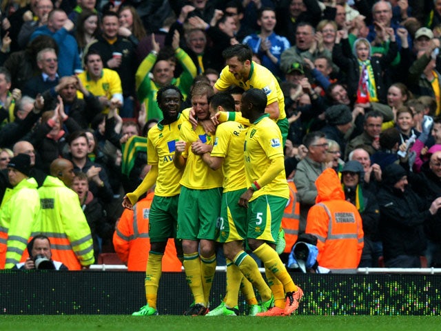 Norwich's Michael Turner celebrates scoring during the Premier League clash with Arsenal on April 13, 2013