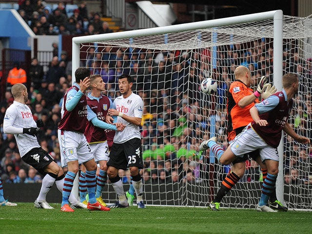 Aston Villa's Fabian Delph scores an own goal in the match against Fulham on April 13, 2013