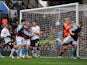 Aston Villa's Fabian Delph scores an own goal in the match against Fulham on April 13, 2013