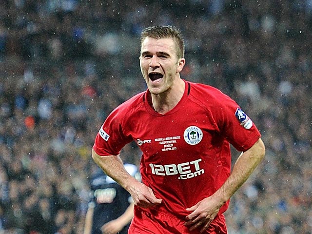 Wigan's Callum McManaman celebrates after scoring his team's second against Millwall on April 13, 2013