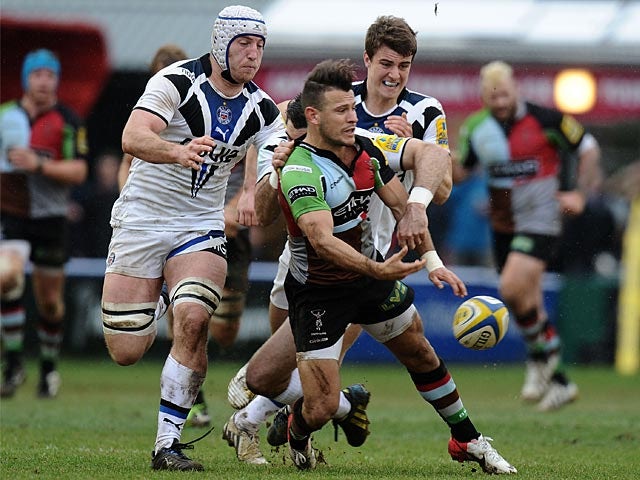 Harlequins' Danny Care is tackled by Bath's Stephen Donald on April 13, 2013