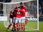 Benfica's Eduardo Salvio is mobbed by teammates after his equaliser against Newcastle on April 11, 2013