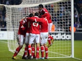 Benfica's Eduardo Salvio is mobbed by teammates after his equaliser against Newcastle on April 11, 2013