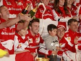 Ferrari driver Fernando Alonso celebrates with teammates after winning the Chinese GP on April 14, 2013