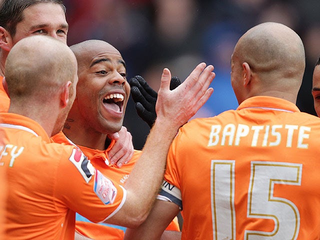 Blackpool's Ludovic Sylvestre is mobbed by teammates after scoring the winning goal against Burnley on April 13, 2013