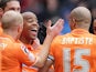 Blackpool's Ludovic Sylvestre is mobbed by teammates after scoring the winning goal against Burnley on April 13, 2013