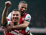 Lukas Podolski is congratulated by Kieran Gibbs after scoring his team's second goal against Norwich on April 13, 2013