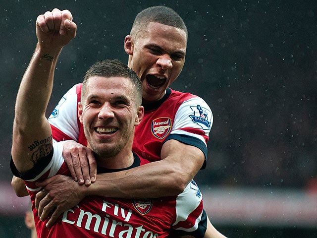 Lukas Podolski is congratulated by Kieran Gibbs after scoring his team's second goal against Norwich on April 13, 2013