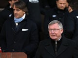Managers Roberto Mancini and Sir Alex Ferguson stand before kick-off of the Manchester Derby on April 8, 2013