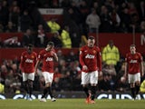 United players walk off dejected following defeat to Man City on April 8, 2013
