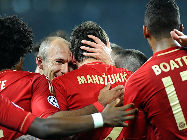 Bayern's Mario Mandzukic is congratulated by team mates after scoring the opening goal against Juventus on April 10, 2013