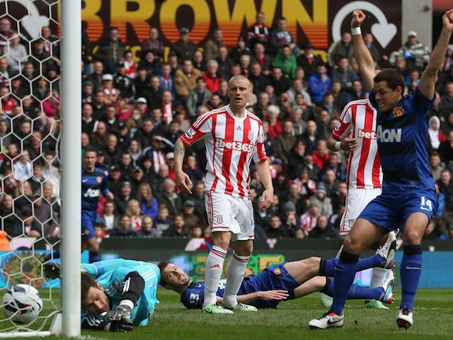 United's Michael Carrick lays on the ground to watch his shot go in against Stoke on April 14, 2013