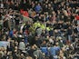 Trouble breaks out in the stands between Milwall fans and police during the match between Wigan and Millwall on April 13, 2013
