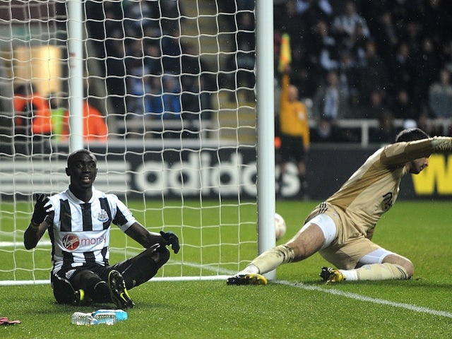Newcastle striker Papiss Cisse sits dejected after a goal is disallowed against Benfica on April 11, 2013