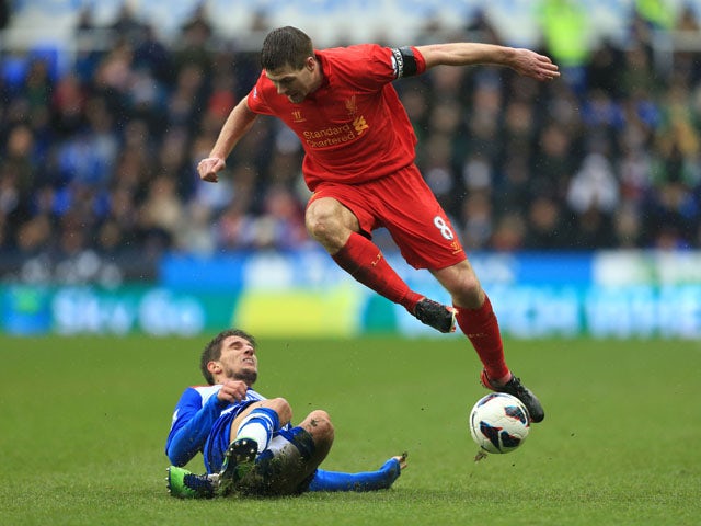 Liverpool's Steven Gerrard is tackled by Reading's Daniel Carrico during the goalless draw on April 13, 2013