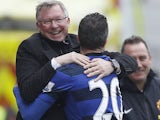 United striker Robin Van Persie celebrates with Sir Alex Ferguson after scoring a penalty against Stoke on April 14, 2013