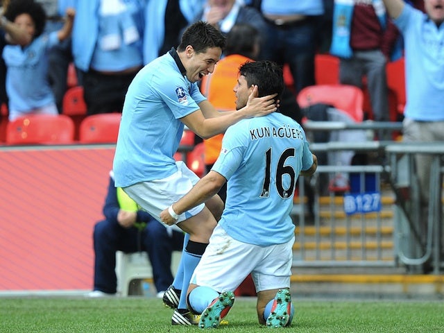City striker Sergio Aguero celebrates a goal against Chelsea with Samir Nasri on April 14, 2013