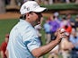 Tim Clark holds up his ball after a birdie on the second during the third round of the Masters on April 13, 2013