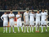 Spurs players stand dejected after losing on penalties to Basel on April 11, 2013