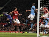 City skipper Vincent Kompany scores an own goal during the Manchester Derby on April 8, 2013