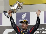 Red Bull driver Sebastian Vettel celebrates with the trophy after winning the Bahrain Grand Prix Sunday on April 21, 2013