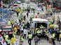 Medical workers aid injured people following explosions at the Boston Marathon on April 15, 2013