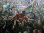 Cardiff City's Leon Barnett is carried by fans after winning promotion to the Premier League on April 16, 2013