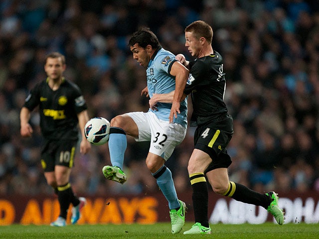Carlos Tevez and James McCarthy battle for the ball on April 17, 2013