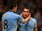 Carlos Tevez is congratulated by teammates Samir Nasri after scoring against Wigan on April 17, 2013
