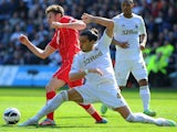 Swansea defender Chico tackles Saints' skipper Adam Lallana on April 20, 2013