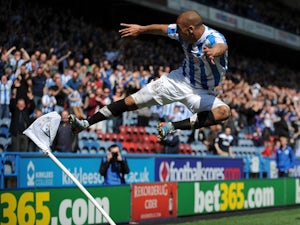 Huddersfield forward James Vaughan celebrates a goal against Millwall on April 20, 2013