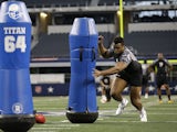 British Olympian Lawrence Okoye participates in a defensive ends position drill during the NFL super regional football combine on April 7, 2013