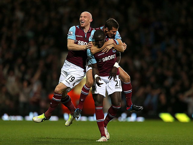 Mohamed Diame is congratulated by teammates Gary O'Neil and James Collins after scoring his team's second against Manchester United on April 17, 2013