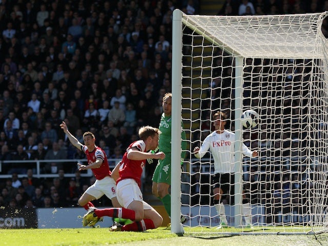 Arsenal defender Per Mertesacker opens the scoring against Fulham on April 20, 2013