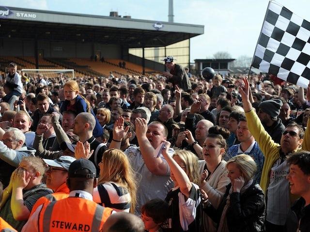 Port Vale fans invade the pitch after the club won promotion to League One on April 20, 2013