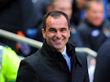 Wigan boss Roberto Martinez smiles prior to kick off in the match against Manchester City on April 17, 2013