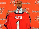 NFL cornerback Darrelle Revis holds up a Tampa Bay Buccaneers jersey during his unveiling to the press on April 22, 2013