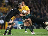 Australia's Digby Loane is tackled by New Zealand's Sam Whitelock and Richie McCaw on Octeober 16, 2011