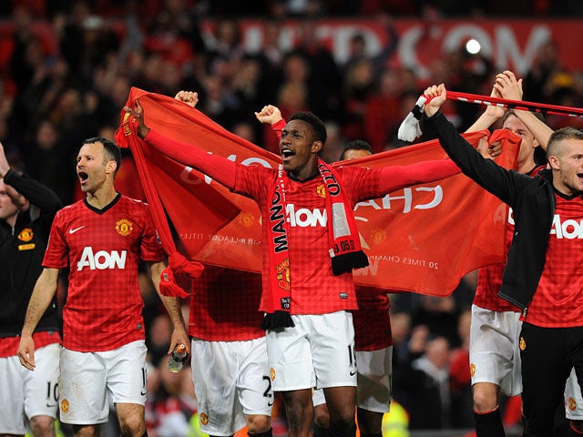 Manchester United players celebrate winning the Premier League title on April 22, 2013