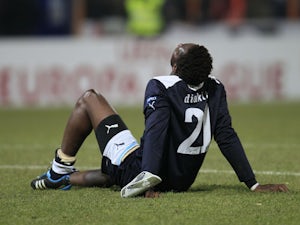 Lazio's Modibo Diakite sit on the pitch during the Europa League match against FC Vaslui on December 1, 2011