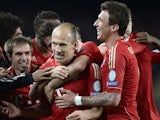 Bayern forward Arjen Robben is mobbed by team mates after scoring the opening goal against Barcelona on May 1, 2013