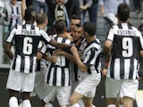 Juve midfielder Arturo Vidal is mobbed by teammates after a goal against Palermo on May 5, 2013