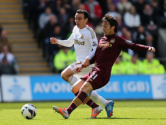 David Silva and Leon Britton battle for the ball on May 4, 2013