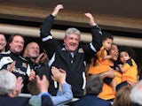 Hull City's manager Steve Bruce celebrates in the stands after his side sealed promotion to the Premier League on May 4, 2013