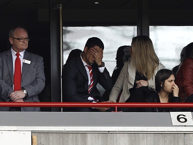 Liverpool's Luis Suarez watches the game against Everton from the stands on May 5, 2013