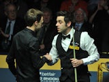 Ronnie O'Sullivan shakes hands with Judd Trump after winning the semi final match on May 4, 2013