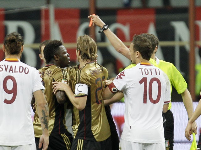 AC Milan midfielder Sulley Muntari reacts after receiving a red card during the Serie A match against Roma on May 12, 2013