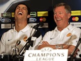 Manchester United manager Alex Ferguson and Cristiano Ronaldo laugh during a news conference