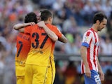 FC Barcelona players celebrate after Atletico Madrid's Gabi Fernandez scores an own goal on May 12, 2013