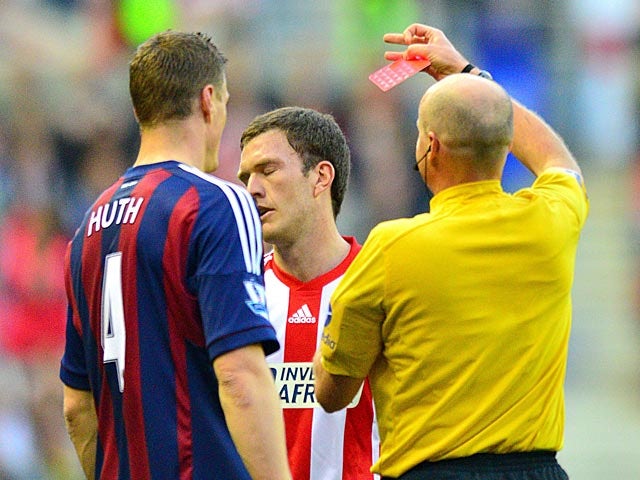 Craig Gardner is shown a red card by referree Lee Mason during the first half against Stoke on May 6, 2013
